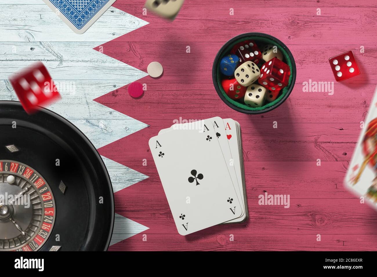 Bahrain casino theme. Aces in poker game, cards and chips on red table