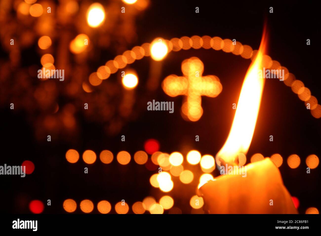 Candle burning inside an Eastern Orthodox church in Romania Stock Photo