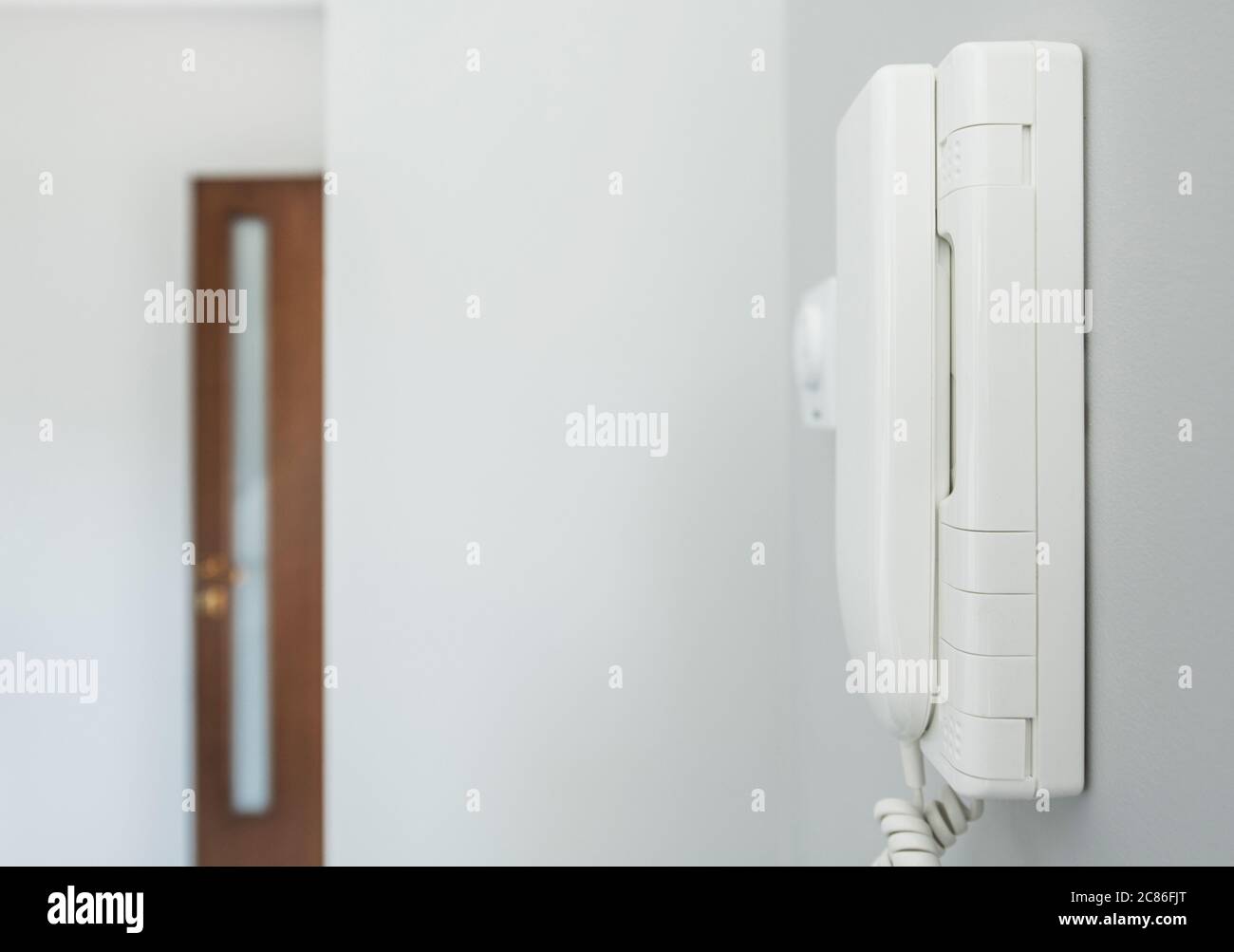 Home System Wired Talking Device on a Wall. Residential Communication Systems. Modern