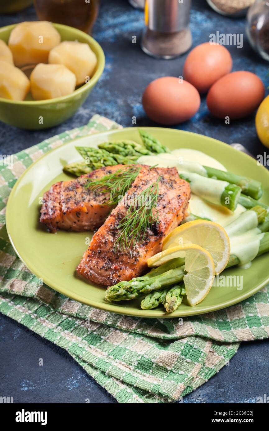 Baked salmon with asparagus and hollandaise sauce.Spring dish Stock Photo