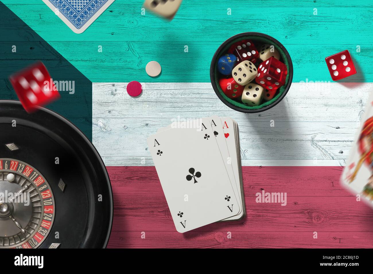 Kuwait casino theme. Aces in poker game, cards and chips on red table