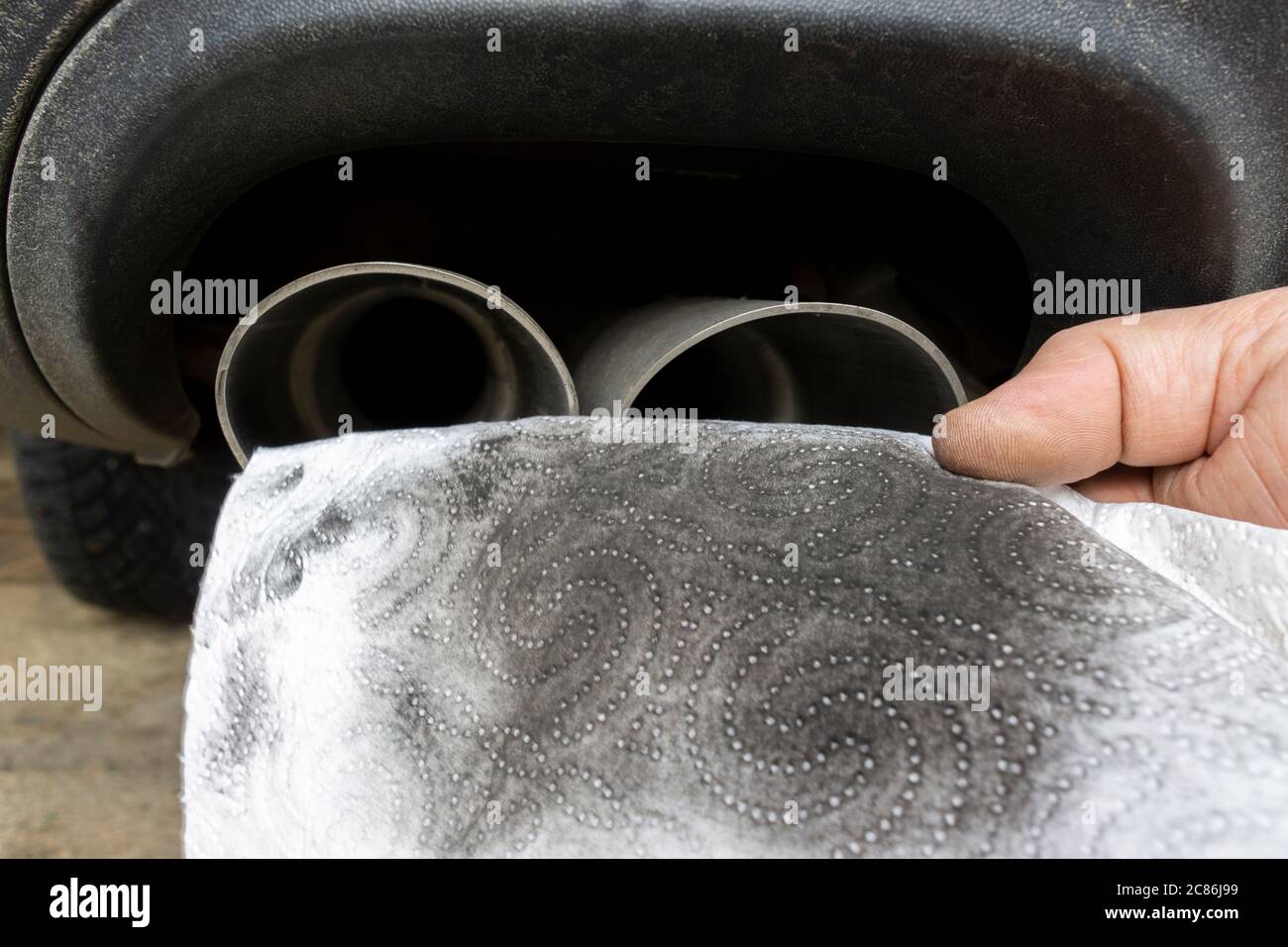 Soot from the exhaust pipe on a white piece of kitchen roll. Stock Photo