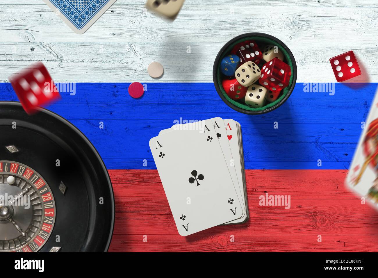 Russia casino theme. Aces in poker game, cards and chips on red table with national flag background. Gambling and betting. Stock Photo