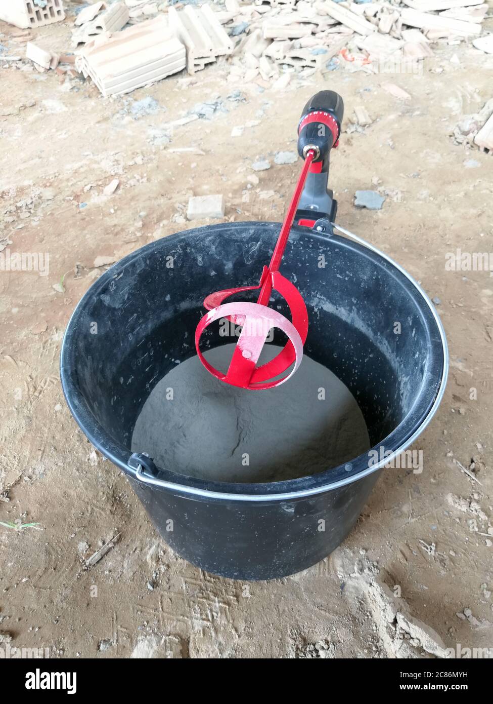 Red drill glue mixer tool on drill for construction Stock Photo Alamy