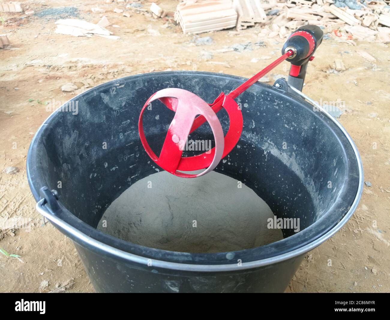 Red drill glue mixer tool on drill for construction Stock Photo Alamy