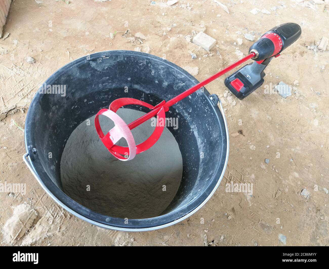 Red drill glue mixer tool on drill for construction Stock Photo Alamy