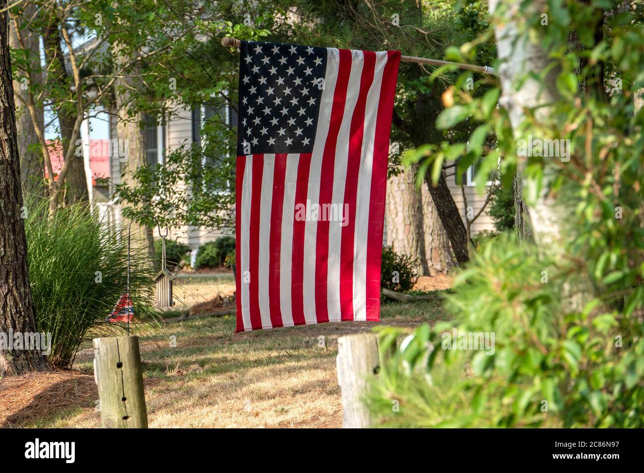Large American flag flies in a rural backyard Stock Photo - Alamy