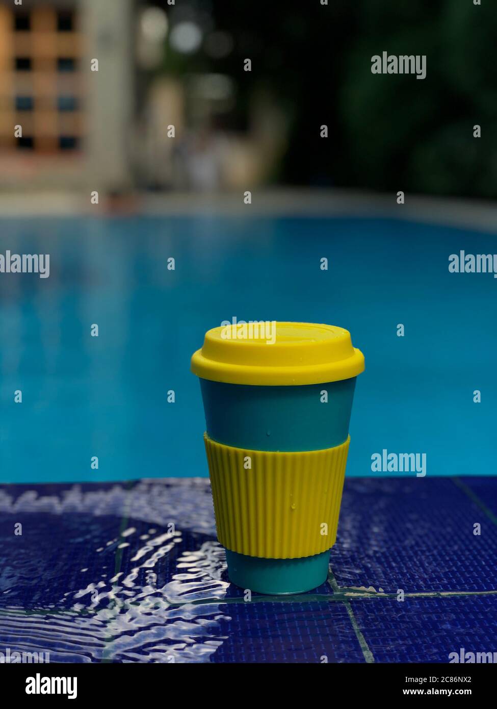 reusable bamboo mug at the swimming pool Stock Photo