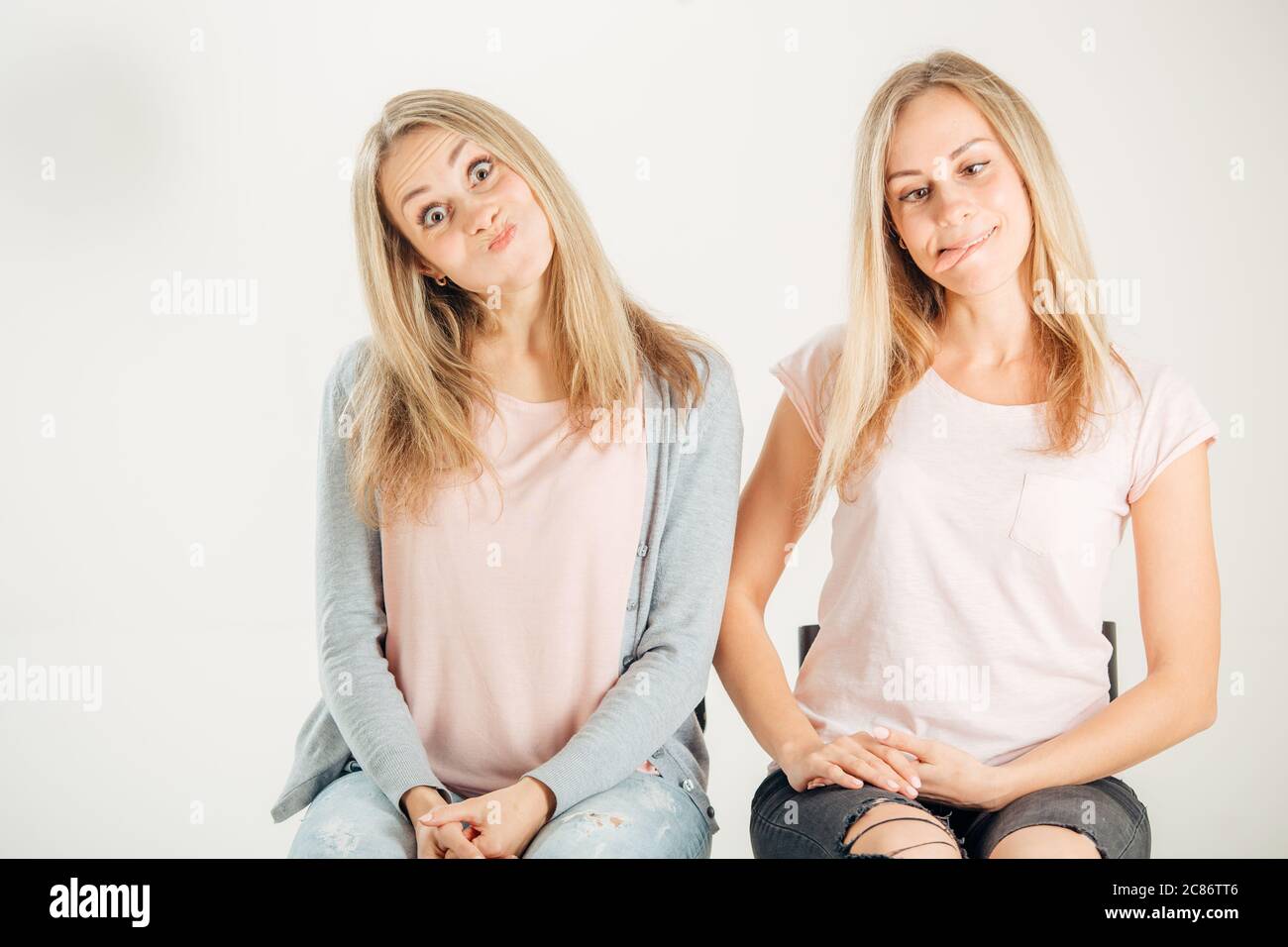 comic funny emotional twins teenager girls make faces and have fun