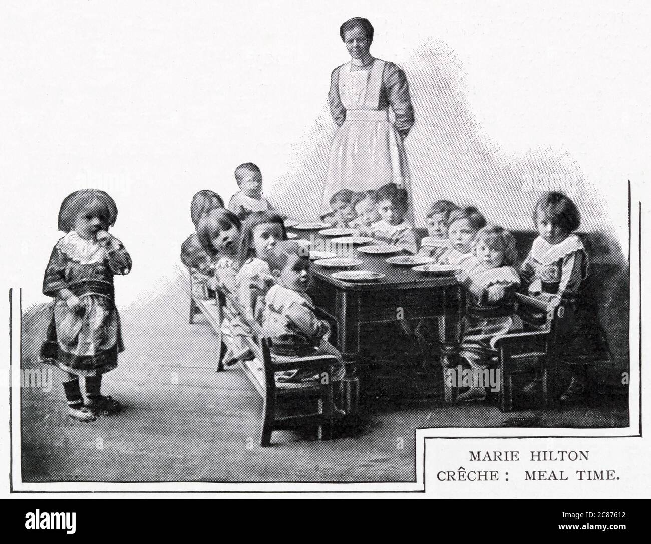 Meal time at Marie Hilton Creche, Stepney Causeway, London. Hilton set up a facility of about 100 infants between the ages of three weeks and five years to be cared for. Poor parents could pay two pence a day for their child to be fed, rested, and dressed in freshly washed clothes and then return to them after work in the evening. Stock Photo
