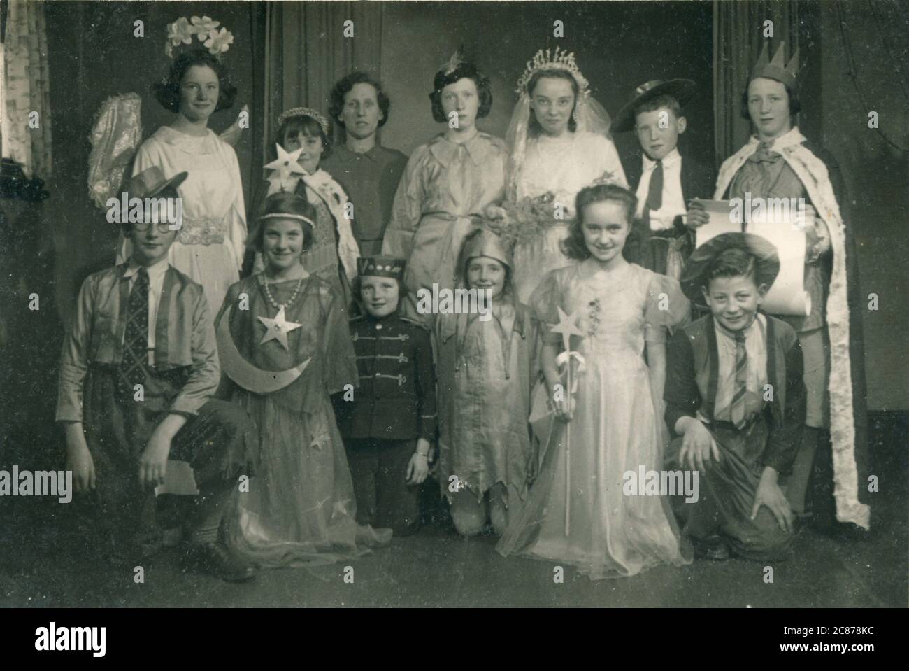 Group of children in fancy dress, in costumes ranging from an angel, to cowboys to a bride. Stock Photo