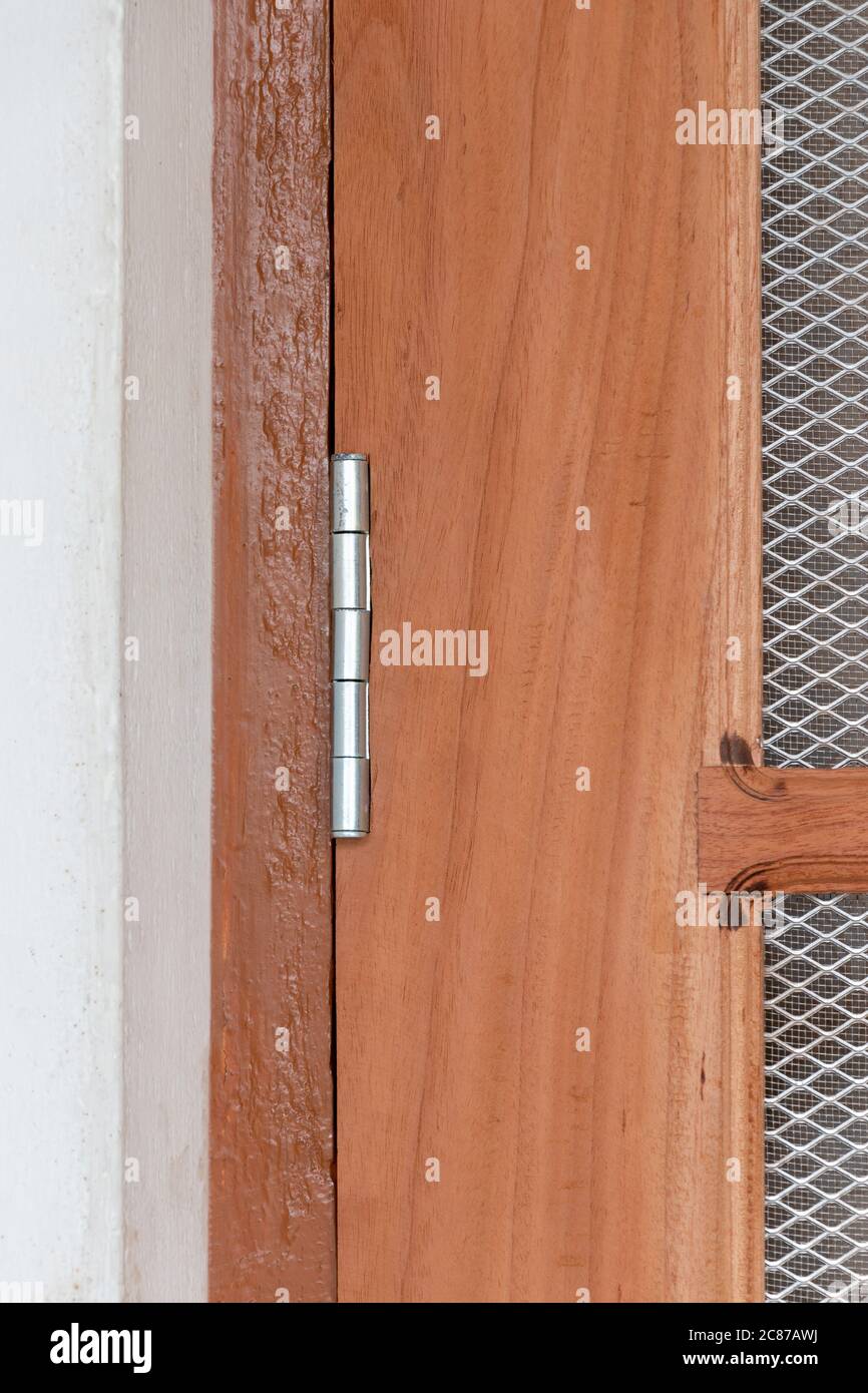 Steel door hinge futted on wood door, close up view Stock Photo