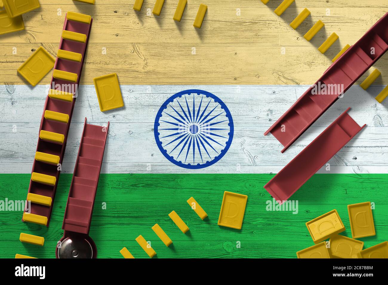 India flag with national background with dominoes on wooden table. Top view. Concept of game. Stock Photo