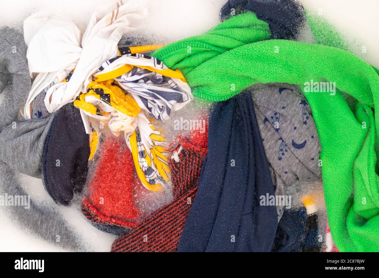 Soaking color clothes in washing powder, household chores Stock Photo