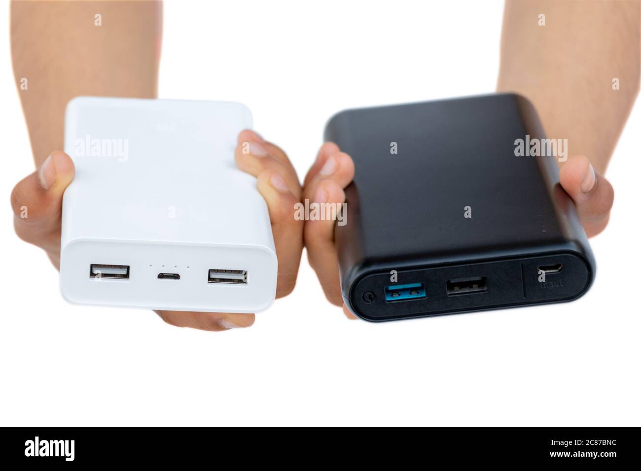 Hands showing battery charger (Power bank) black and white isolated on a white background Stock Photo