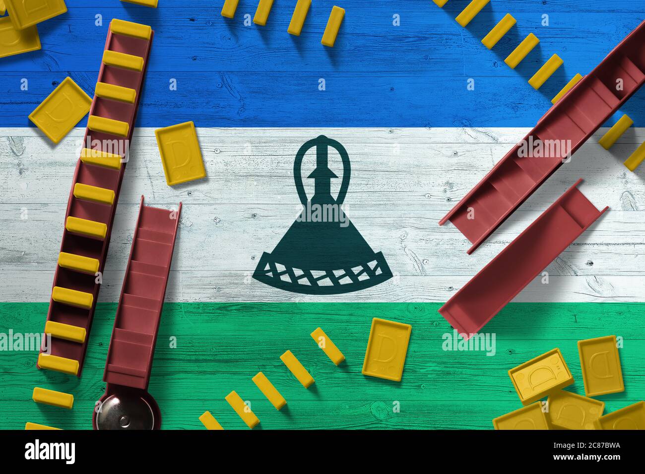 Lesotho flag with national background with dominoes on wooden table