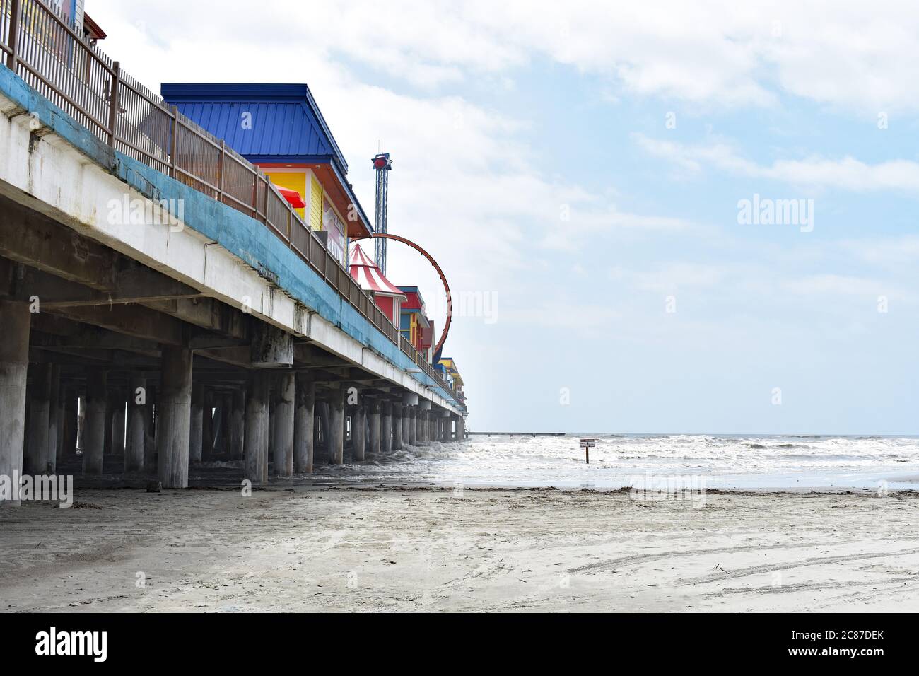 Looking up at Galveston Island Historic Pleasure Pier from the beach
