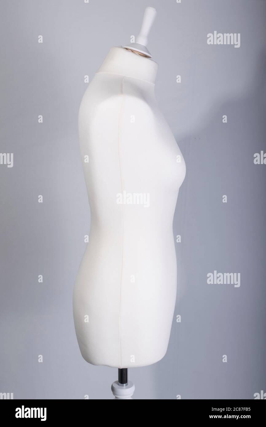 A Tailors Mannequin on a grey background Stock Photo