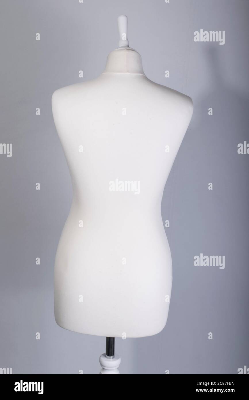 A Tailors Mannequin on a grey background Stock Photo