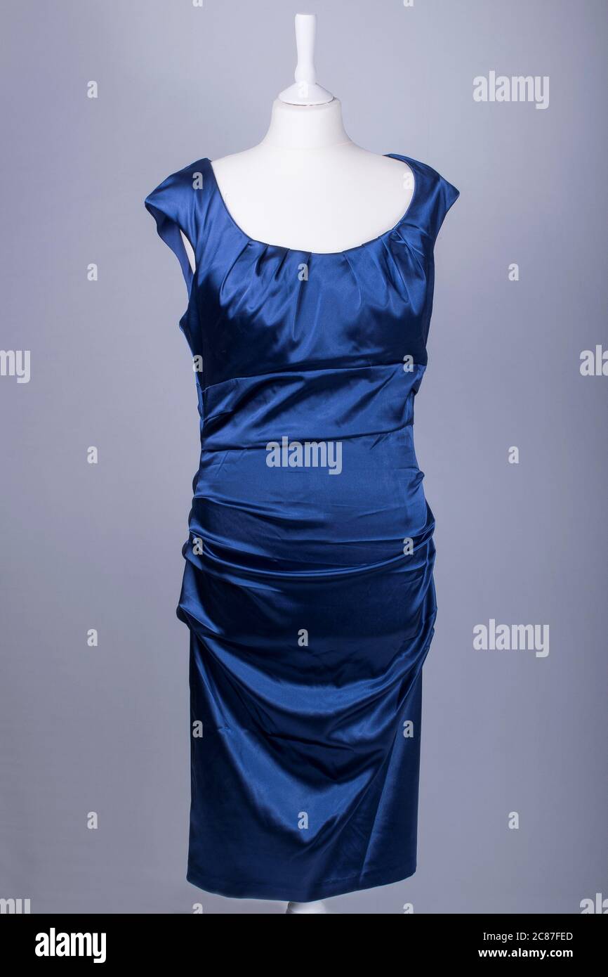 A Tailors Mannequin dressed in a Blue Satin Dress Stock Photo