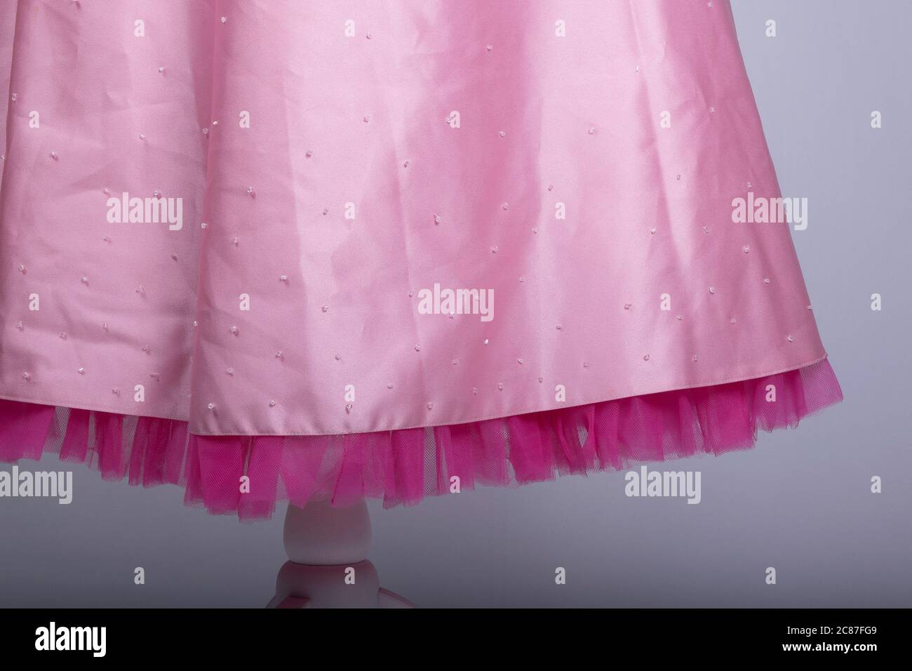 A Tailors Mannequin dressed in a Pink Dress Stock Photo