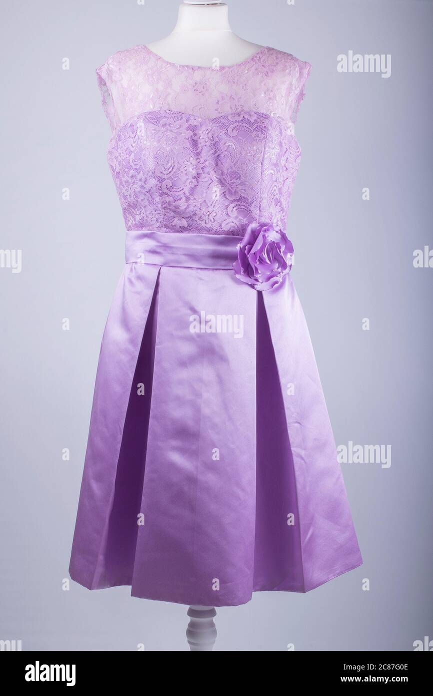 A Tailors Mannequin dressed in a Purple Dress Stock Photo
