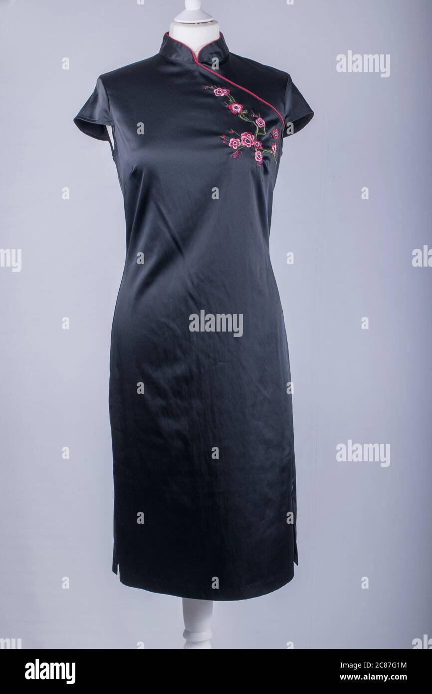 A Tailors Mannequin dressed in a Black and Red Chinese Dress Stock Photo