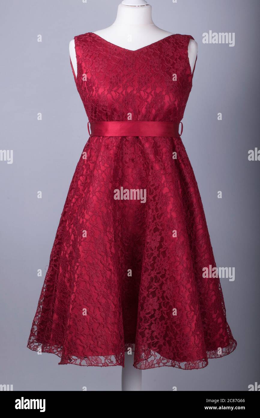 A Tailors Mannequin dressed in a Red Floral Netted Dress Stock Photo