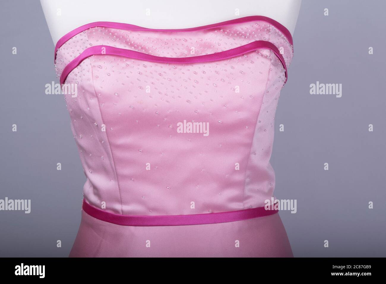 A Tailors Mannequin dressed in a Pink Dress Stock Photo