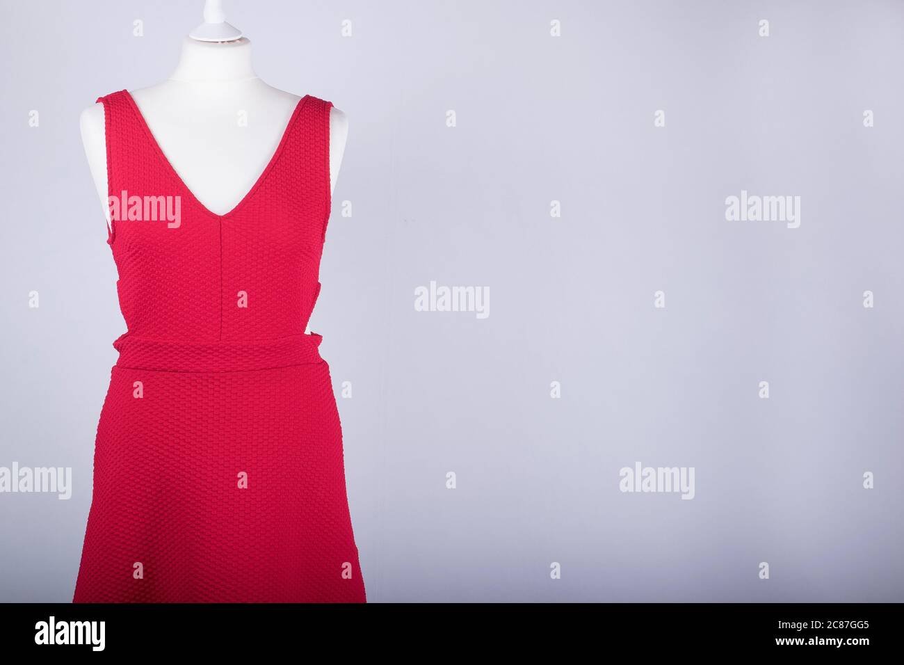 A Tailors Mannequin dressed in a Red Dress Stock Photo