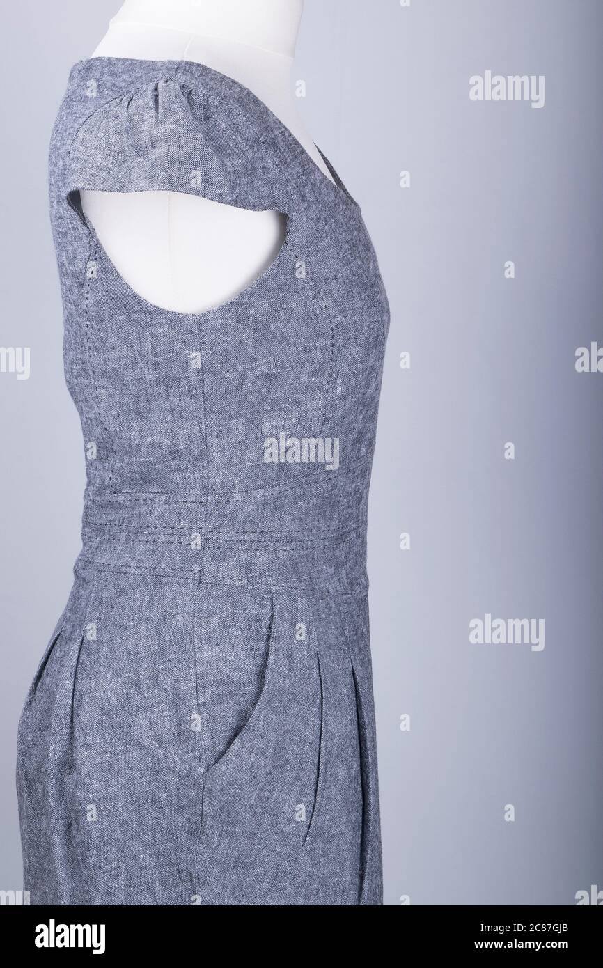 A Tailors Mannequin dressed in a Grey Fitted Work Dress Stock Photo - Alamy