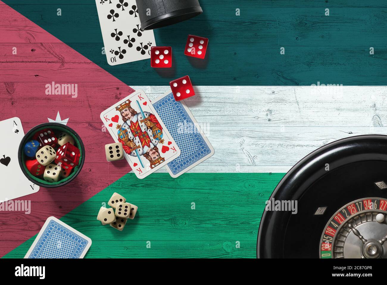 Jordan casino theme. Aces in poker game, cards and chips on red table with national wooden flag