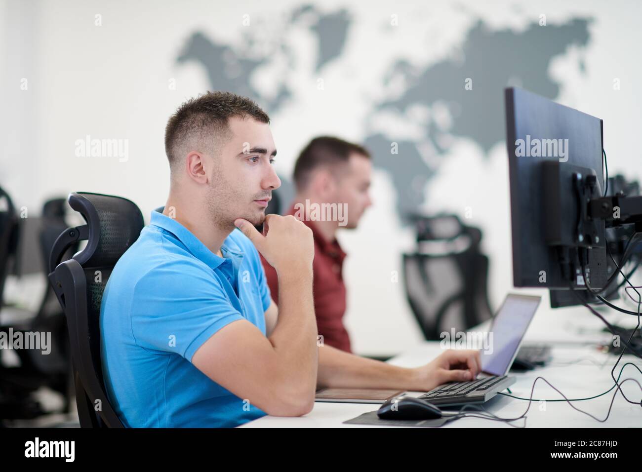 startup business, two male software developers working on computer at new modern open plan office Stock Photo