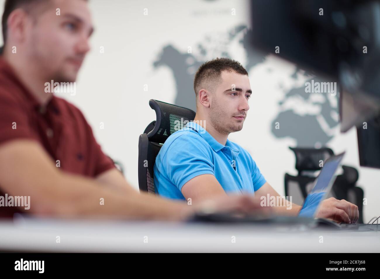 startup business, two male software developers working on computer at new modern open plan office Stock Photo