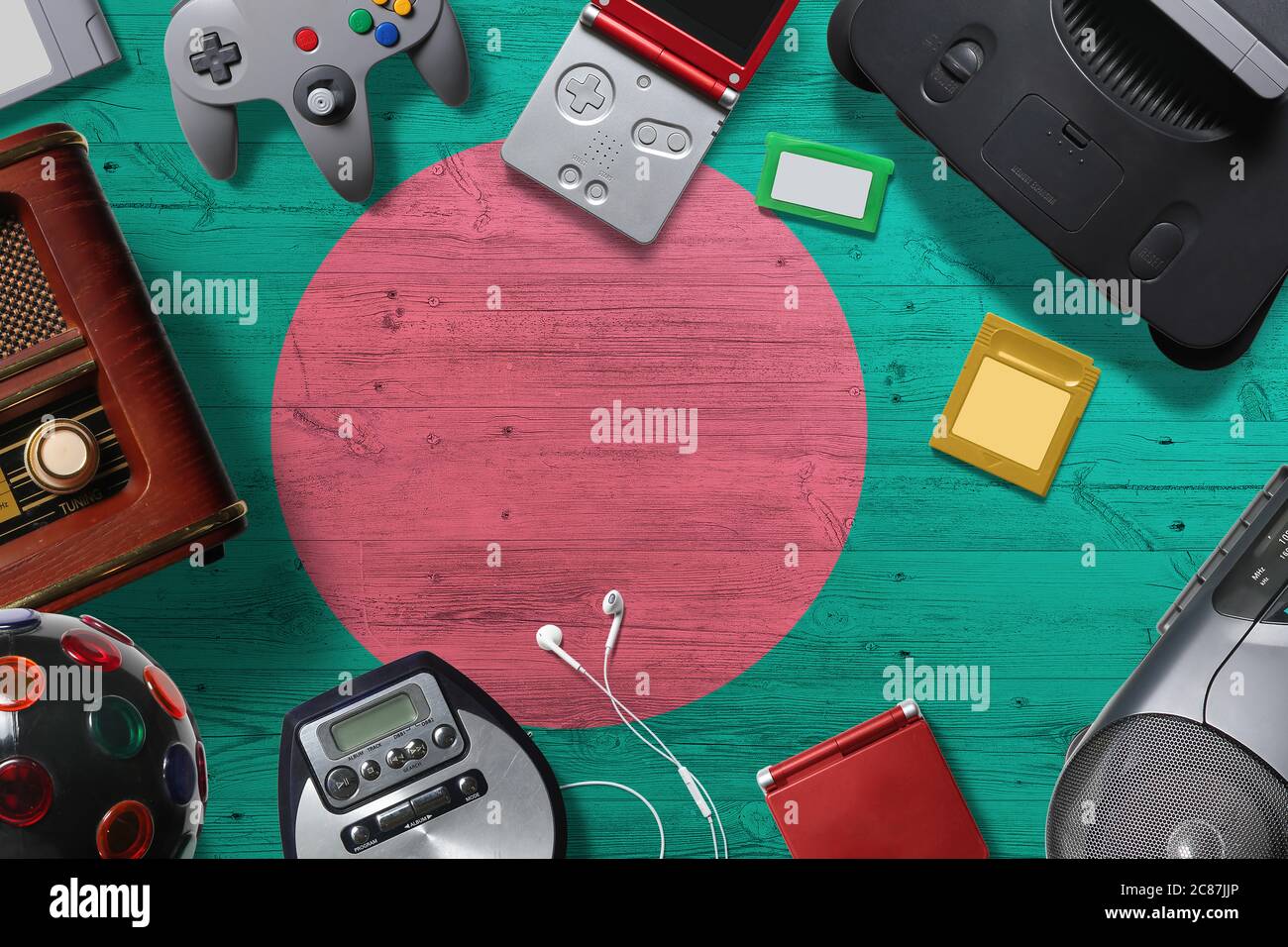 Bangladesh retro gaming concept. A collection of retro video game controllers shot from above on a national background. Stock Photo