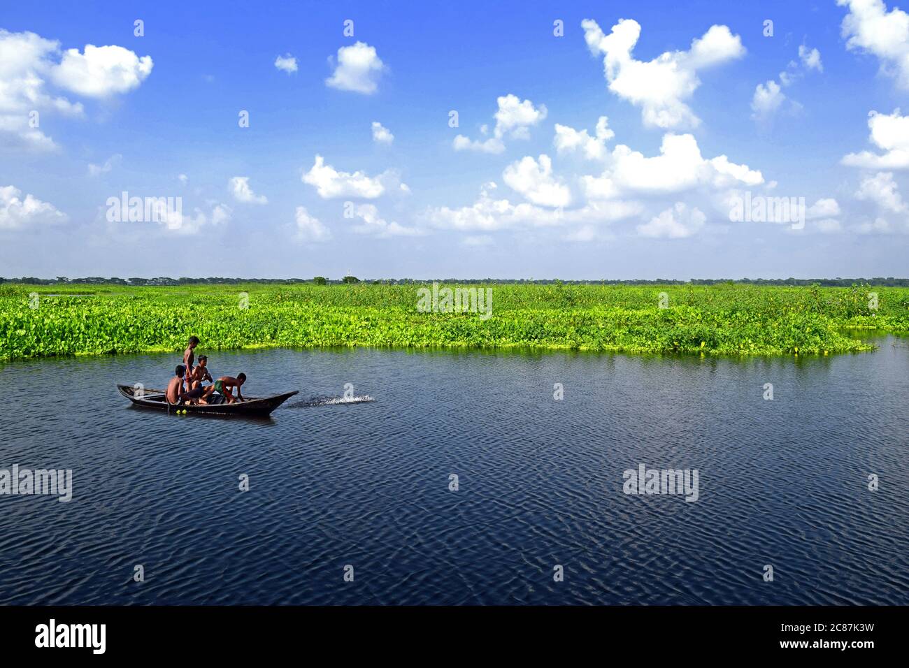 Childrens travel in beautiful pond with a boat Stock Photo