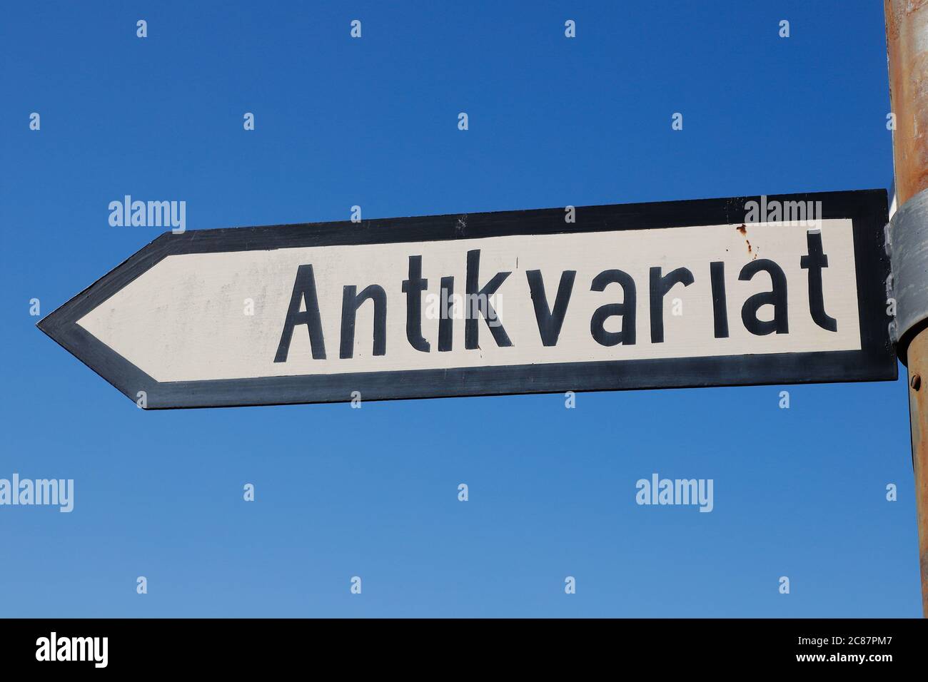 Swedish signpost with direction to a antiquarian. Stock Photo