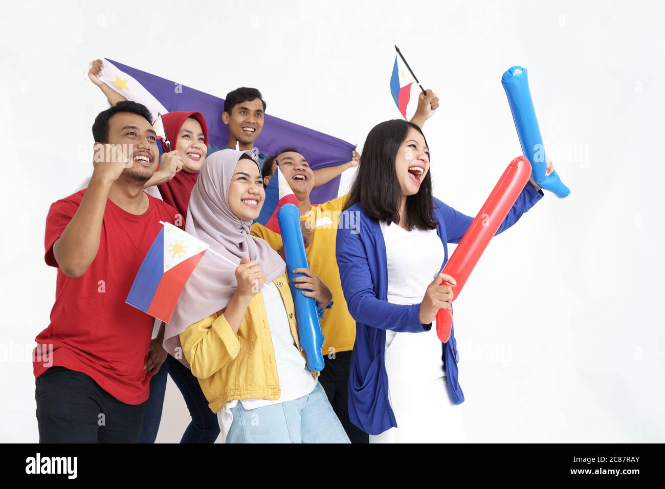 filipino group of people holding philippines flag celebrating
