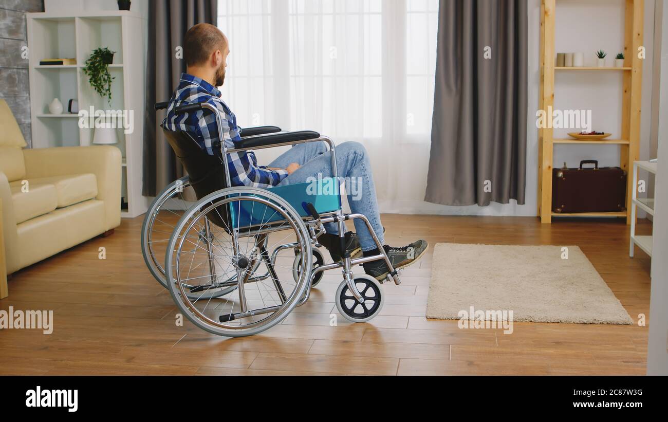 Invalid young guy and depressed in wheelchair Stock Photo - Alamy