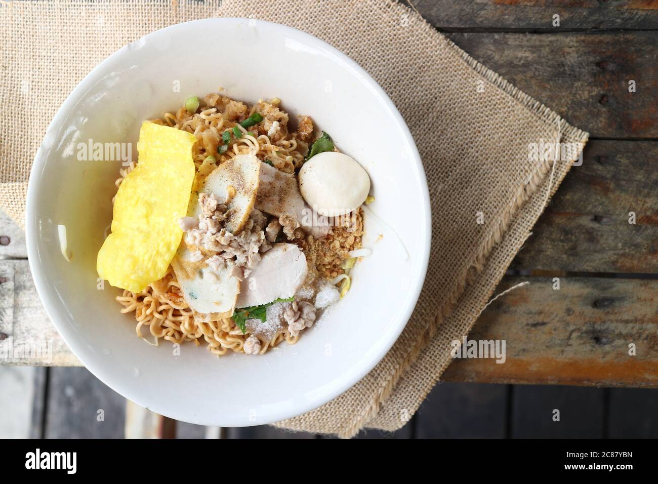 Thai egg noodle with fish ball and minced pork on the sackcloth of wood table Stock Photo Alamy