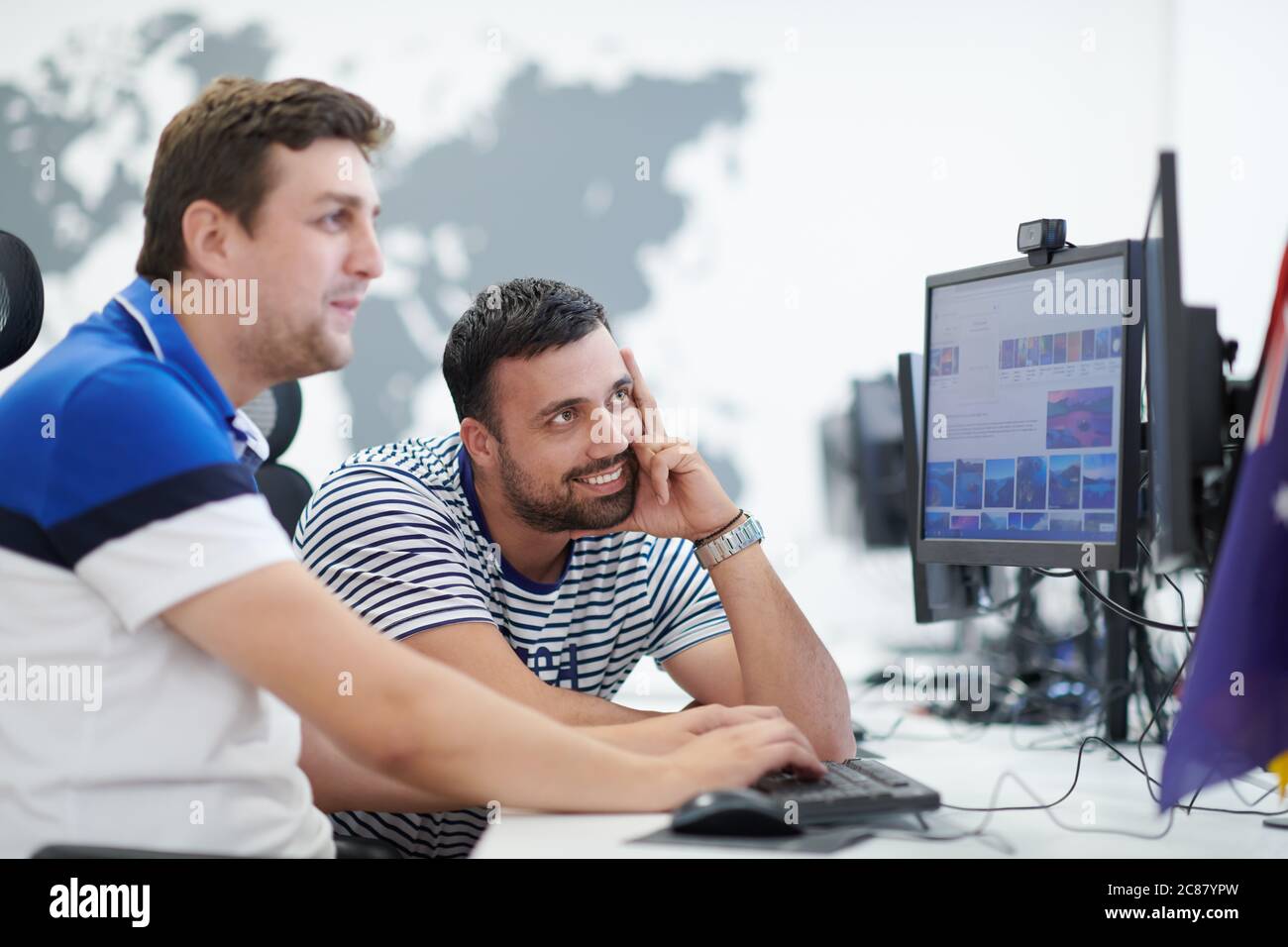 startup business, two male software developers working on computer at new modern open plan office Stock Photo
