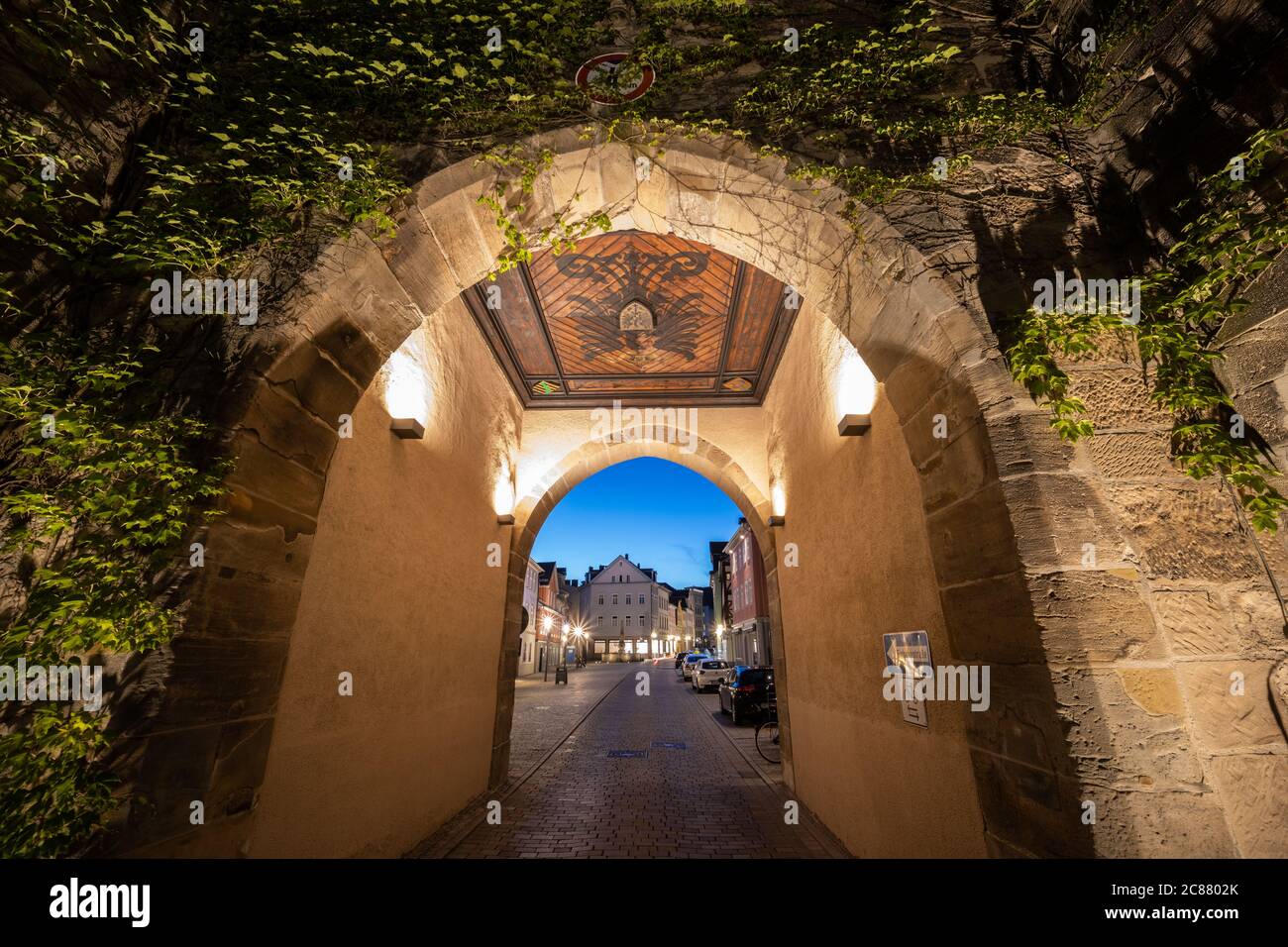View through city gate 'Ketschentor' into the old town at night Stock Photo