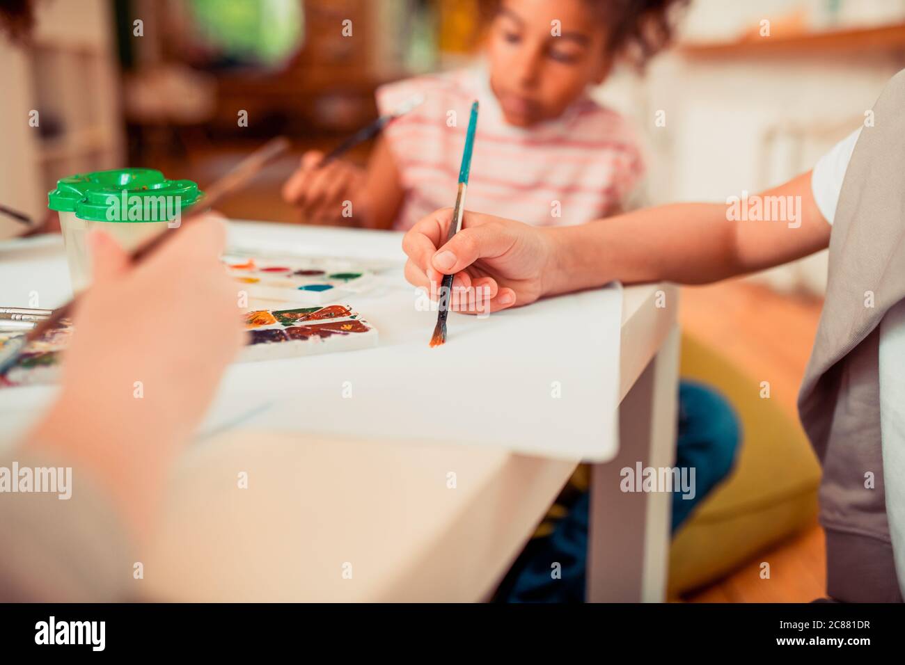 Children painting with the brush and watercolors Stock Photo - Alamy