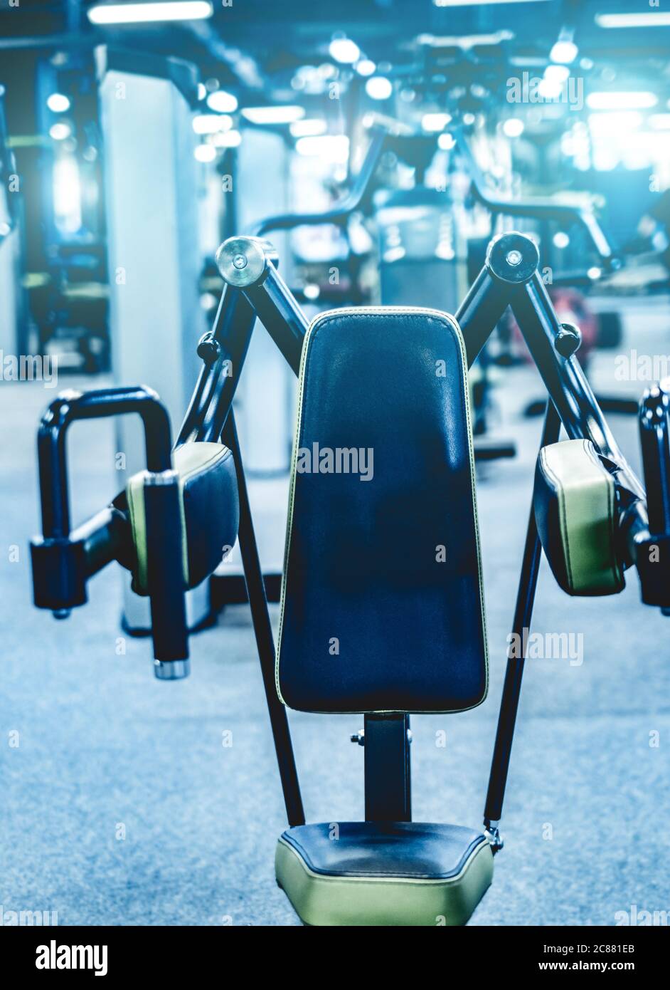 Fitness and bodybuilder machine for shoulders in gym hall Stock Photo