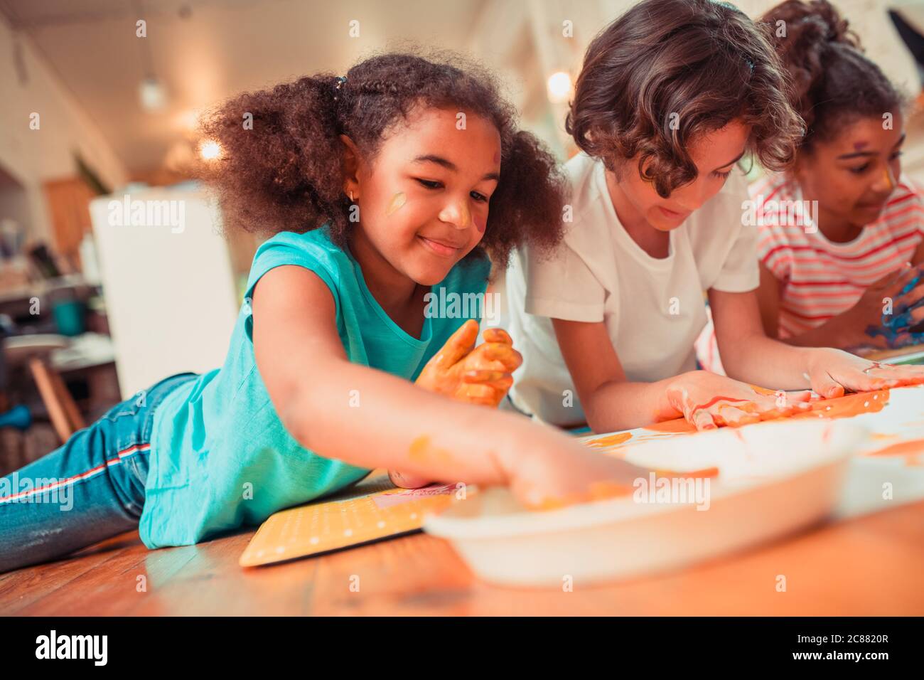 Children playing paint together hi-res stock photography and images - Alamy