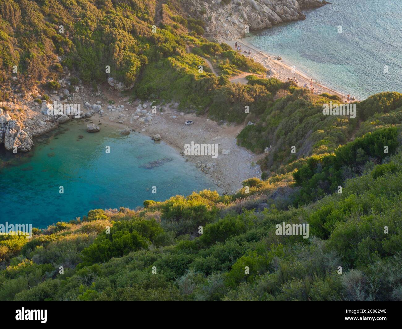 Corfu, Greece, Porto Timoni. View of the most famous double beach and bay  in Afionas from the view point on the path. Sunset golden golden hour light  Stock Photo - Alamy