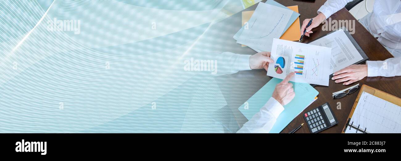 Two business people analyzing charts; panoramic banner Stock Photo - Alamy
