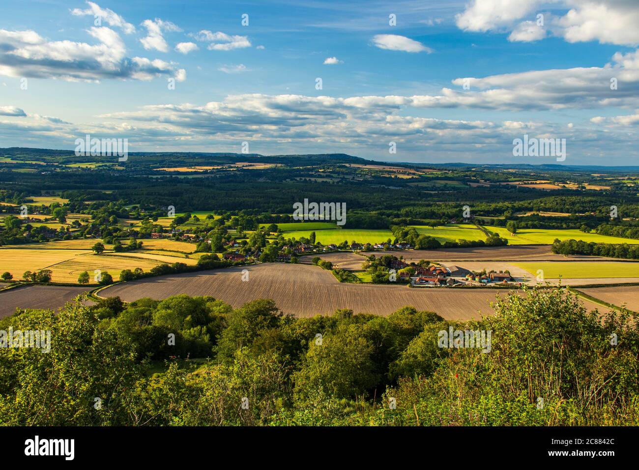 Peaceful evening on manorfarm down overlooking the village of Heyshott and the surrey hills from the south downs in south east England Stock Photo