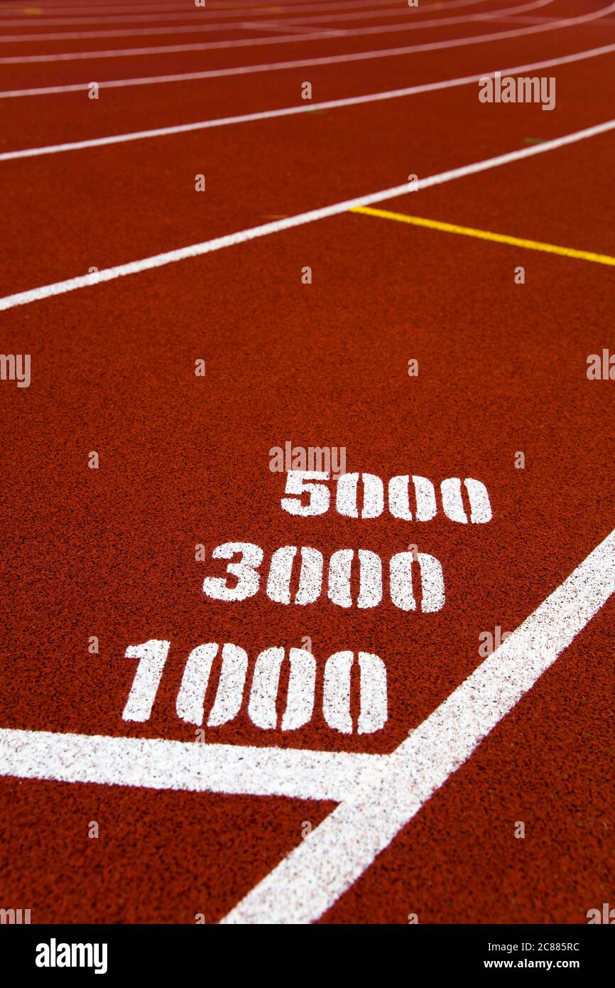 Closeup of the 1000, 3000 and 5000 meters marks on red stadium running