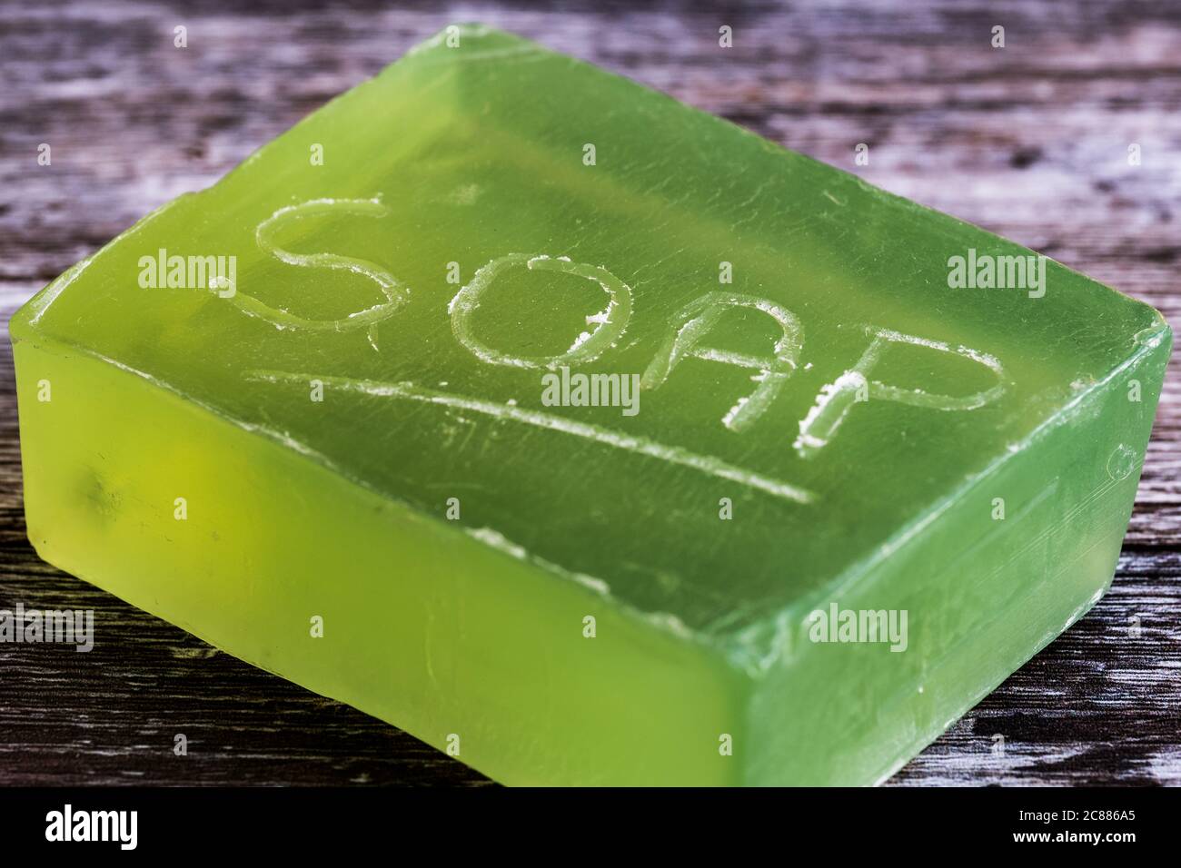 Closeup, shallow focus of a bar of natural soap with engraved letters